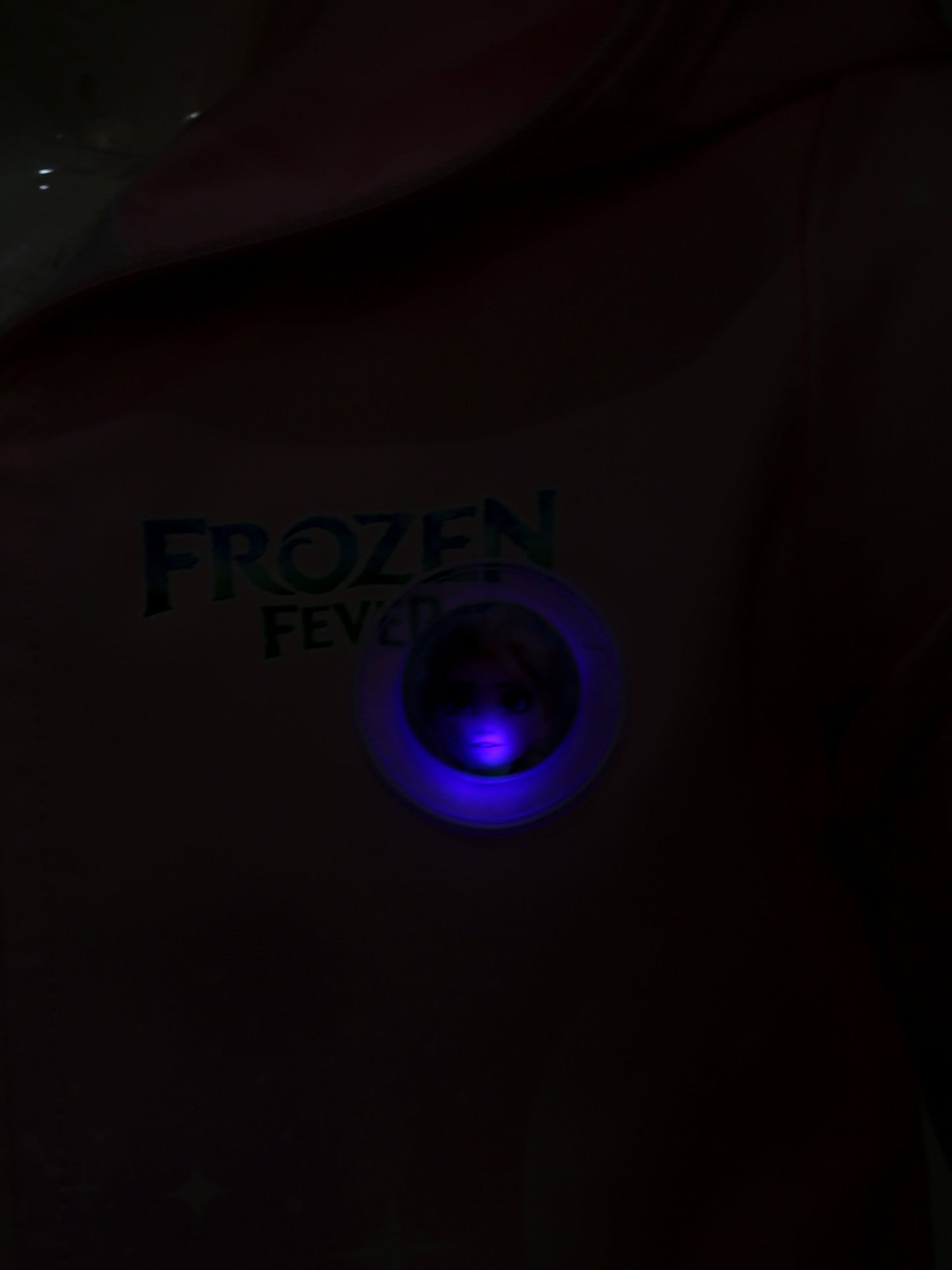 Dark shirt with 'Frozen Fever' text and blue light in the center